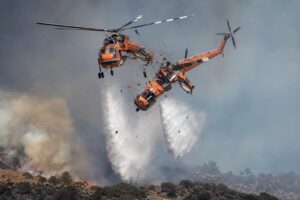 Two firefighting helicopters collide midair fighting blazes in Greece